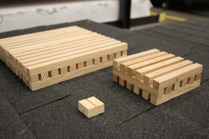 Calibrated brands are used in the “burning brand test.” Pictured are the A (12” x 12”), B (6” x 6”) and C (1 1/2” x 1 1/2”) brands. Brand selection for testing depends on the desired system rating. The brands are stored in a cabinet with controlled temperature and humidity. Humidity has a significant impact on how a brand will burn. To the right, UL consumer safety director John Drengenberg holds an A brand. 