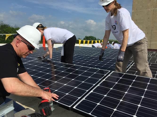 NRG Home Solar employees volunteer during Global Giving Week to install solar panels atop New Jersey non-profit, HomeFront