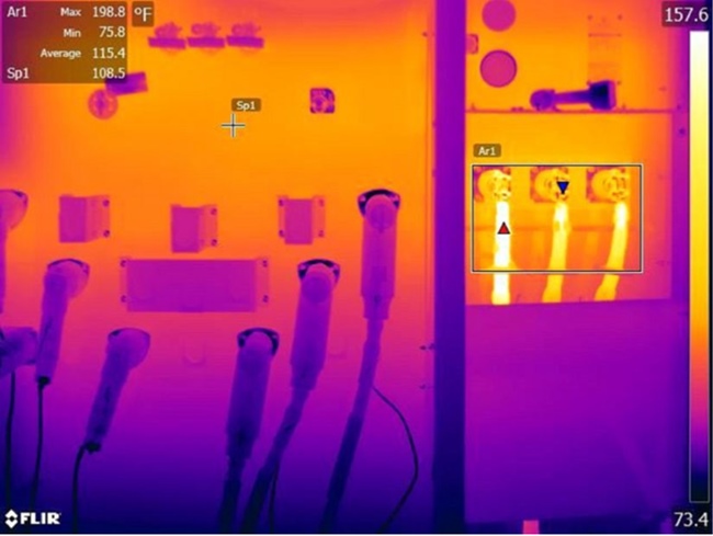The IR image reveals three loose or damaged connections at a pad-mount transformer. The three connections are the three phase low voltage cabling connecting this transformer to the inverter output. Loose or damaged connections are responsible for the increase in heat. The good connections remain cooler.