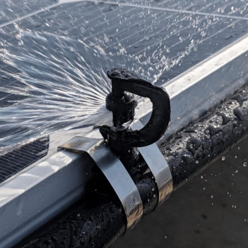 water spraying onto a solar panel being cleaned